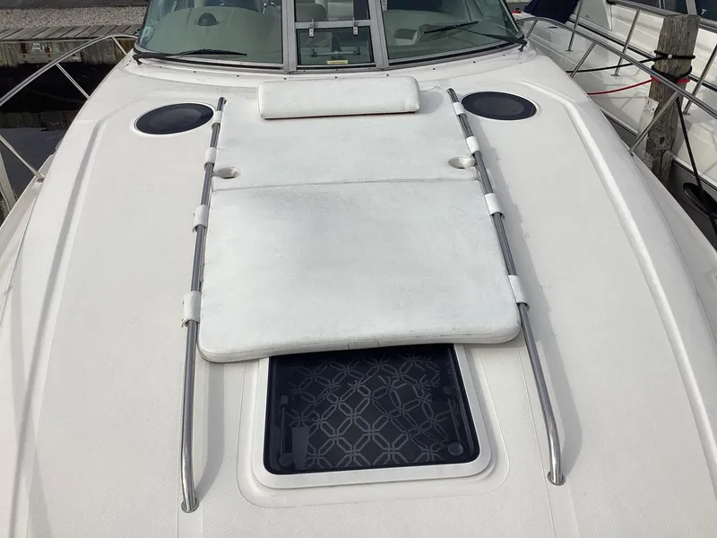 Slide: The Image of 2005 Sea Ray 320 Sundancer boat deck with sunpad and hatch. - 4