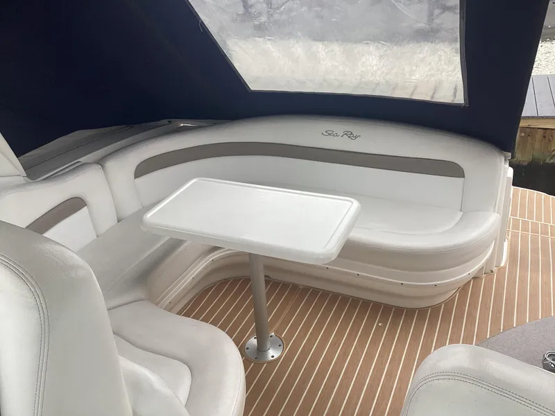 Slide: The Image of 2005 Sea Ray 320 Sundancer interior with white seating and table. - 8