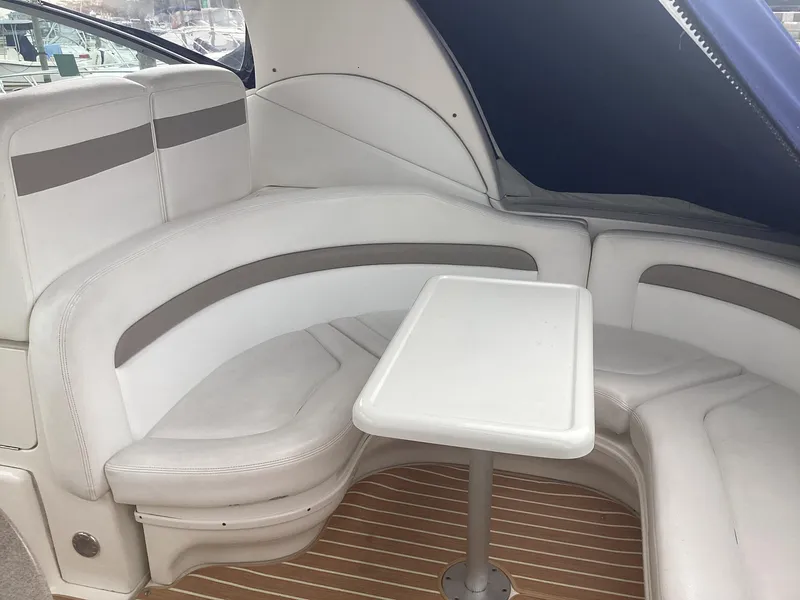 Slide: The Image of 2005 Sea Ray 320 Sundancer interior with white seating and table. - 9