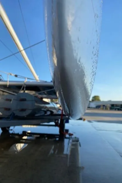 Slide: The Image of Close-up of a 1989 Nacra 5.8 catamaran hull on a sunny day. - 12