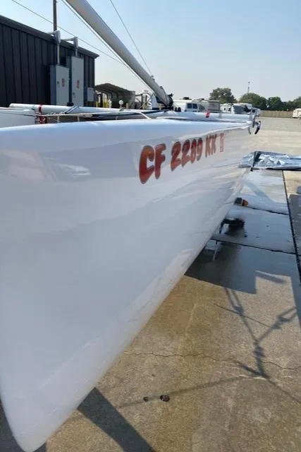 Slide: The Image of 1989 Nacra 5.8 sailboat on a wet dock, side view. - 19