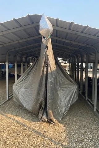 Slide: The Image of Covered 1989 Nacra 5.8 catamaran stored under a metal shelter. - 20