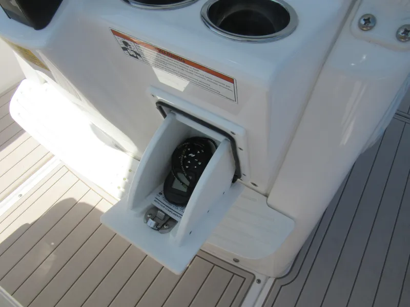 Slide: The Image of 2019 Everglades 243 CC boat console with storage compartment and cup holders. - 11
