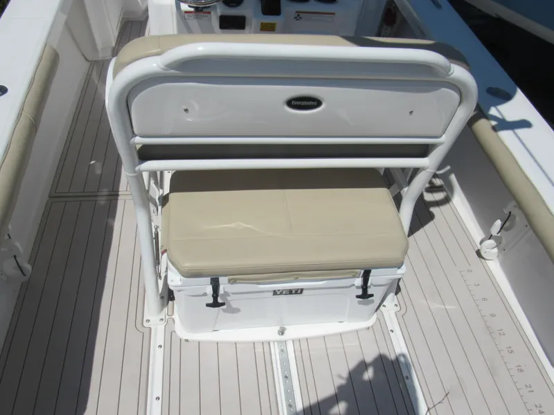 Slide: The Image of 2019 Everglades 243 CC boat interior with cushioned seating and YETI cooler. - 17