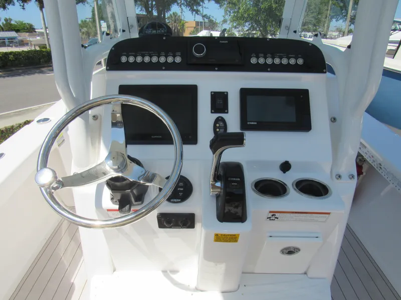 Slide: The Image of 2019 Everglades 243 CC boat console with steering wheel and navigation controls. - 3
