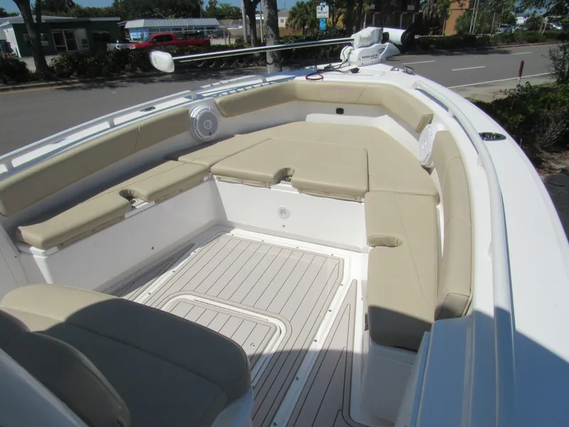 Slide: The Image of 2019 Everglades 243 CC boat with beige cushioned seating and spacious deck. - 30