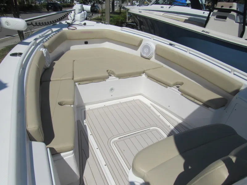 Slide: The Image of 2019 Everglades 243 CC boat with beige cushioned seating and white deck. - 31