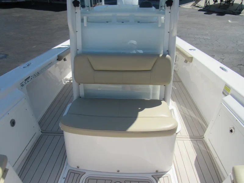 Slide: The Image of 2019 Everglades 243 CC boat interior with beige seating and white deck. - 32
