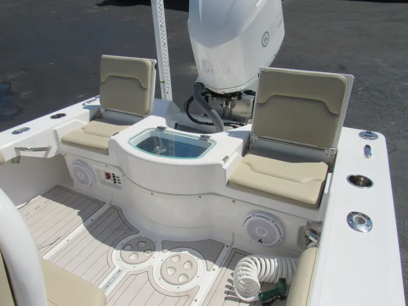 Slide: The Image of 2019 Everglades 243 CC boat interior with seating, livewell, and Yamaha outboard motor. - 34