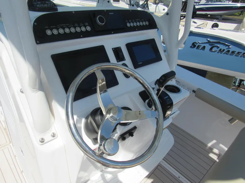 Slide: The Image of 2019 Everglades 243 CC boat helm with steering wheel and control panel. - 4