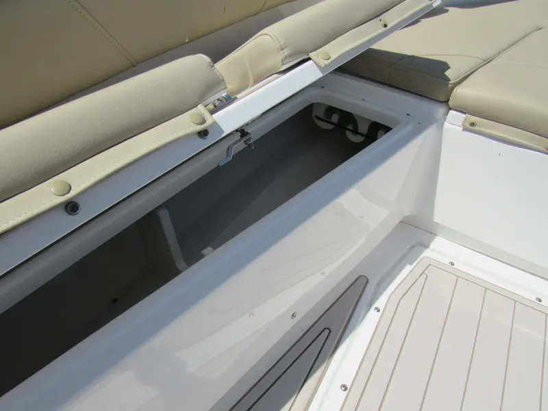 Slide: The Image of Open storage compartment on a 2019 Everglades 243 CC boat with beige seating. - 6