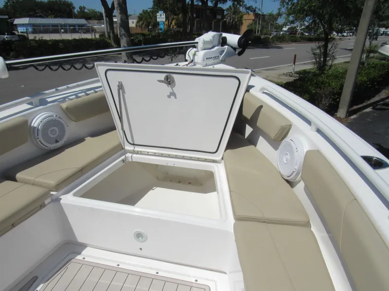Slide: The Image of 2019 Everglades 243 CC boat with open storage compartment and cushioned seating. - 7