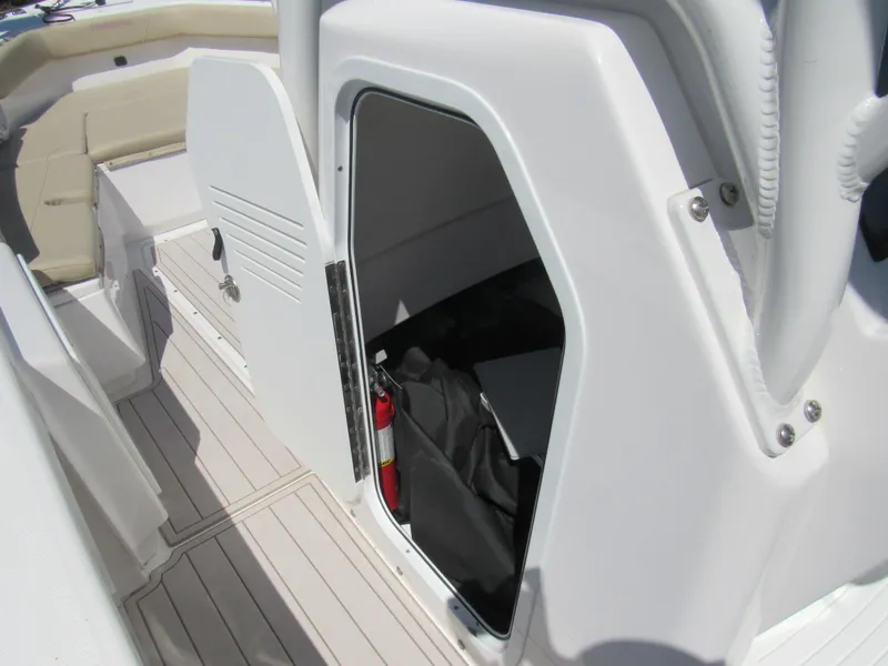 Slide: The Image of 2019 Everglades 243 CC boat interior with open storage compartment and seating area. - 9