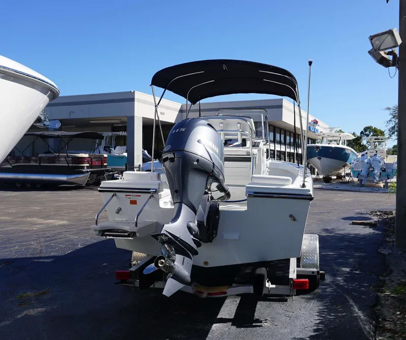Slide: The Image of 2024 Parker 1801CC boat with Yamaha outboard motor on trailer, parked outdoors. - 10