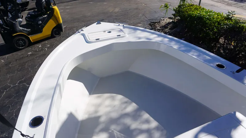 Slide: The Image of 2024 Parker 1801CC boat interior with clean white deck and seating area. - 13