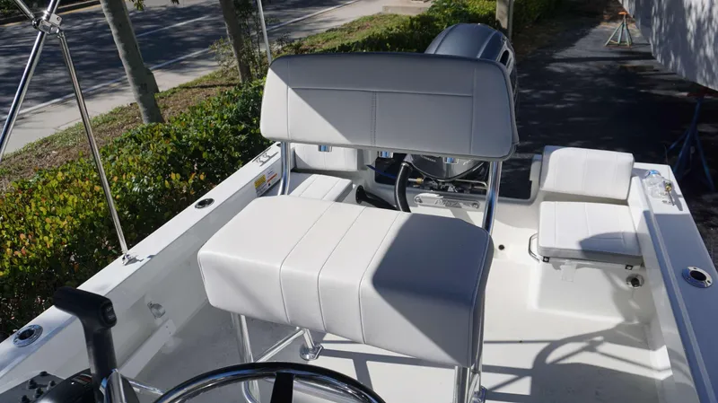 Slide: The Image of 2024 Parker 1801CC boat interior with white seating and steering wheel. - 15