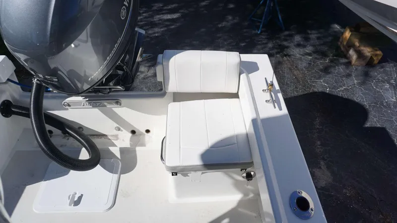 Slide: The Image of 2024 Parker 1801CC boat with white seating and Yamaha outboard motor. - 16
