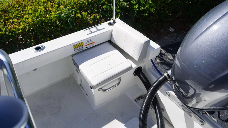 Slide: The Image of 2024 Parker 1801CC boat interior with seating and engine detail. - 17