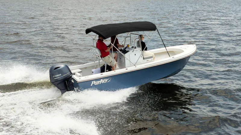 Slide: The Image of 2024 Parker 1801CC boat cruising on water with Yamaha engine. - 2