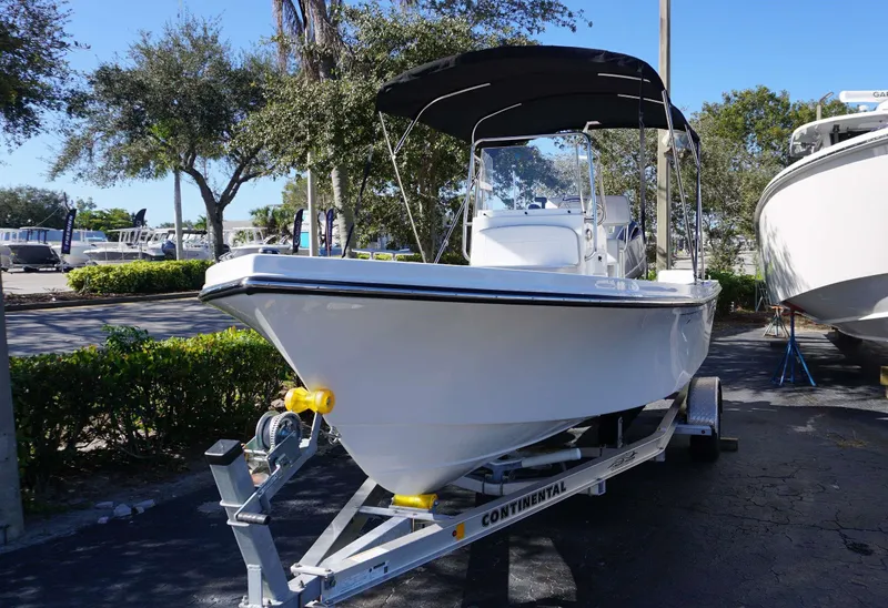 Slide: The Image of 2024 Parker 1801CC boat on trailer, parked outdoors under clear blue sky. - 5