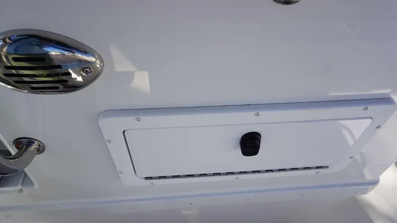 Slide: The Image of 2024 Parker 1801CC boat detail showing a storage compartment and chrome fixture. - 8