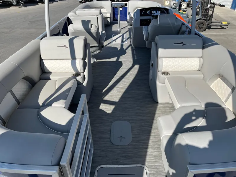 Slide: The Image of 2023 Bennington 25LSRTDSP pontoon boat interior with luxurious seating and modern design. - 11