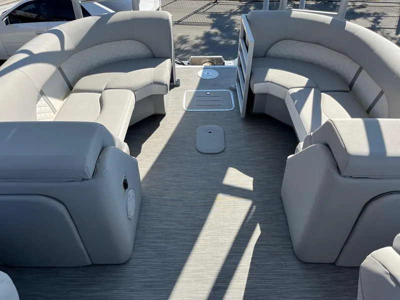Slide: The Image of 2023 Bennington 25LSRTDSP pontoon boat interior with plush seating and modern design. - 12