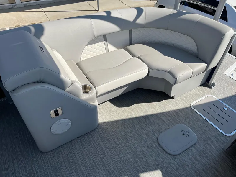 Slide: The Image of 2023 Bennington 25LSRTDSP boat interior with gray seating and cup holder. - 13