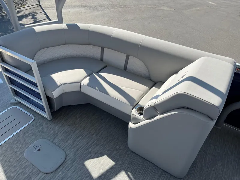 Slide: The Image of 2023 Bennington 25LSRTDSP boat interior with gray seating and cup holder. - 14