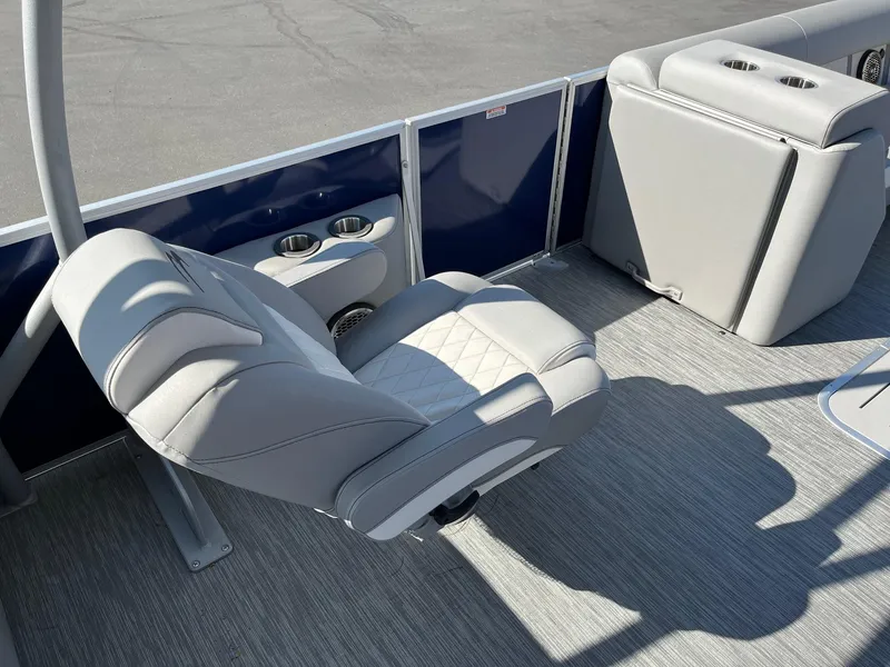 Slide: The Image of 2023 Bennington 25LSRTDSP boat interior with gray seating and cup holders. - 15