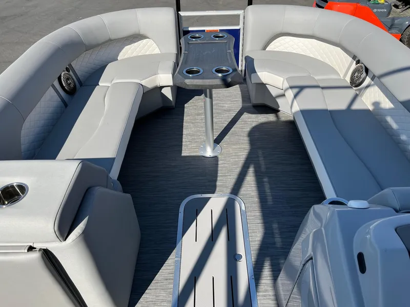 Slide: The Image of 2023 Bennington 25LSRTDSP pontoon boat interior with gray seating and table. - 17