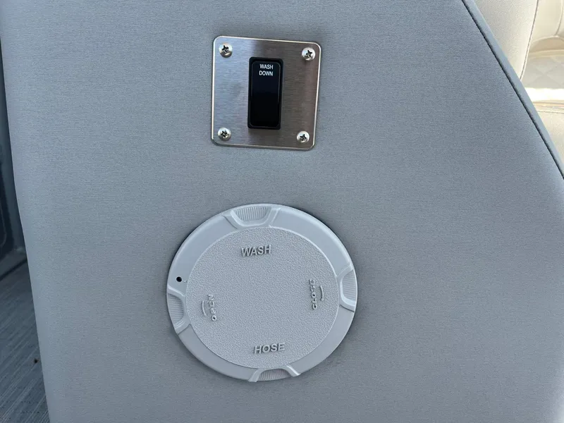 Slide: The Image of Washdown switch and hose access on 2023 Bennington 25LSRTDSP boat. - 21