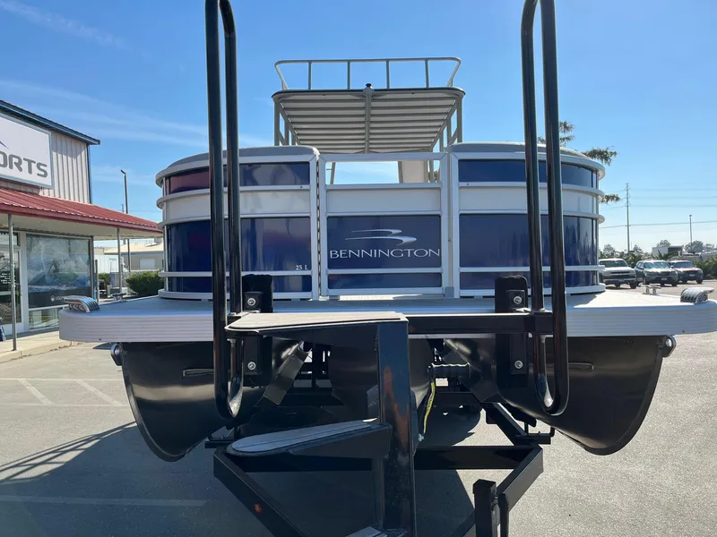 Slide: The Image of 2023 Bennington 25LSRTDSP pontoon boat on trailer, rear view in parking lot. - 4