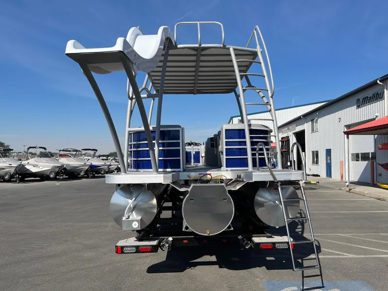 Slide: The Image of 2023 Bennington 25LSRTDSP pontoon boat with slide and ladder at a marina. - 9