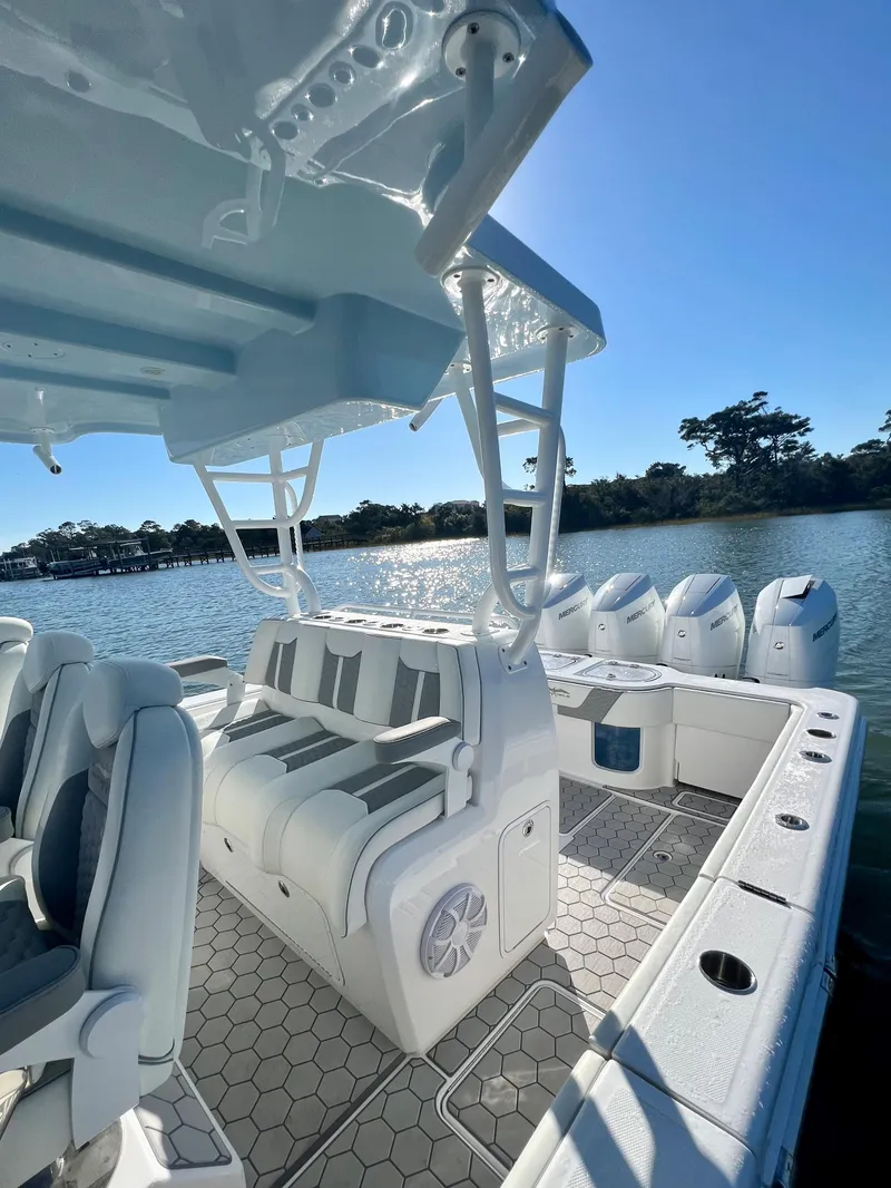 Slide: The Image of 2024 Invincible 43 Open Fisherman boat on a serene lake. - 15