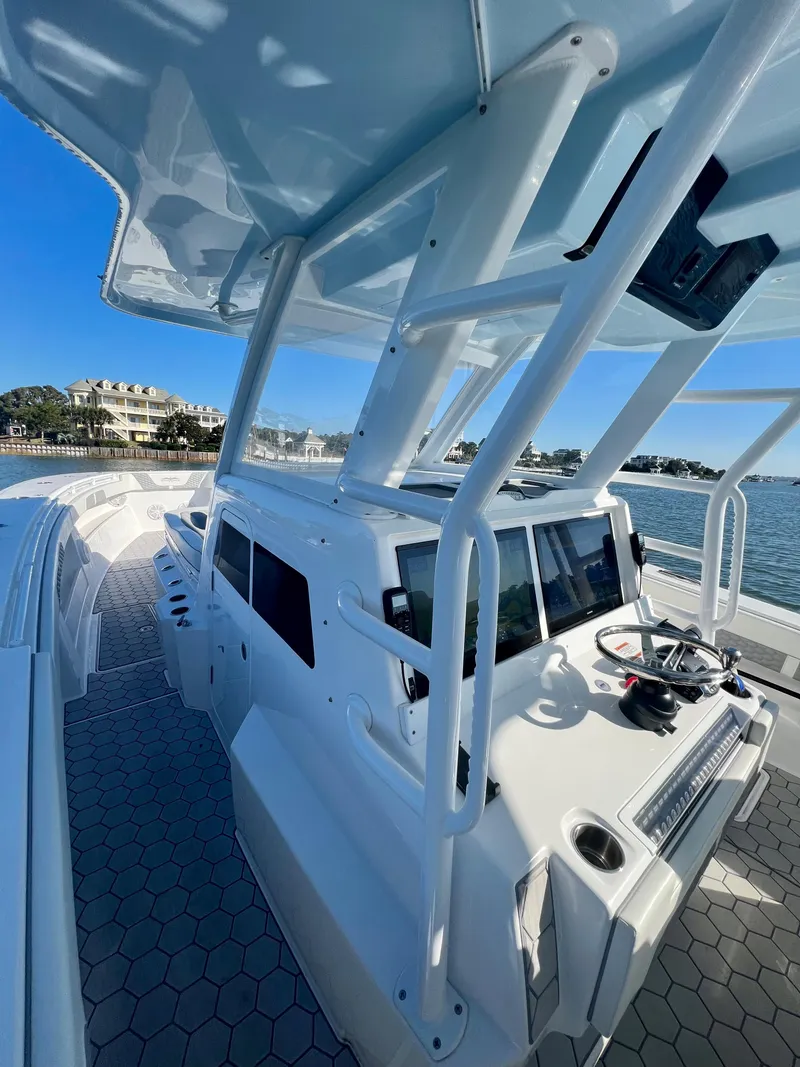 Slide: The Image of 2024 Invincible 43 Open Fisherman boat docked by the water. - 19