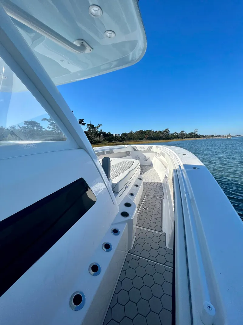 Slide: The Image of 2024 Invincible 43 Open Fisherman boat on calm water with clear blue sky. - 22