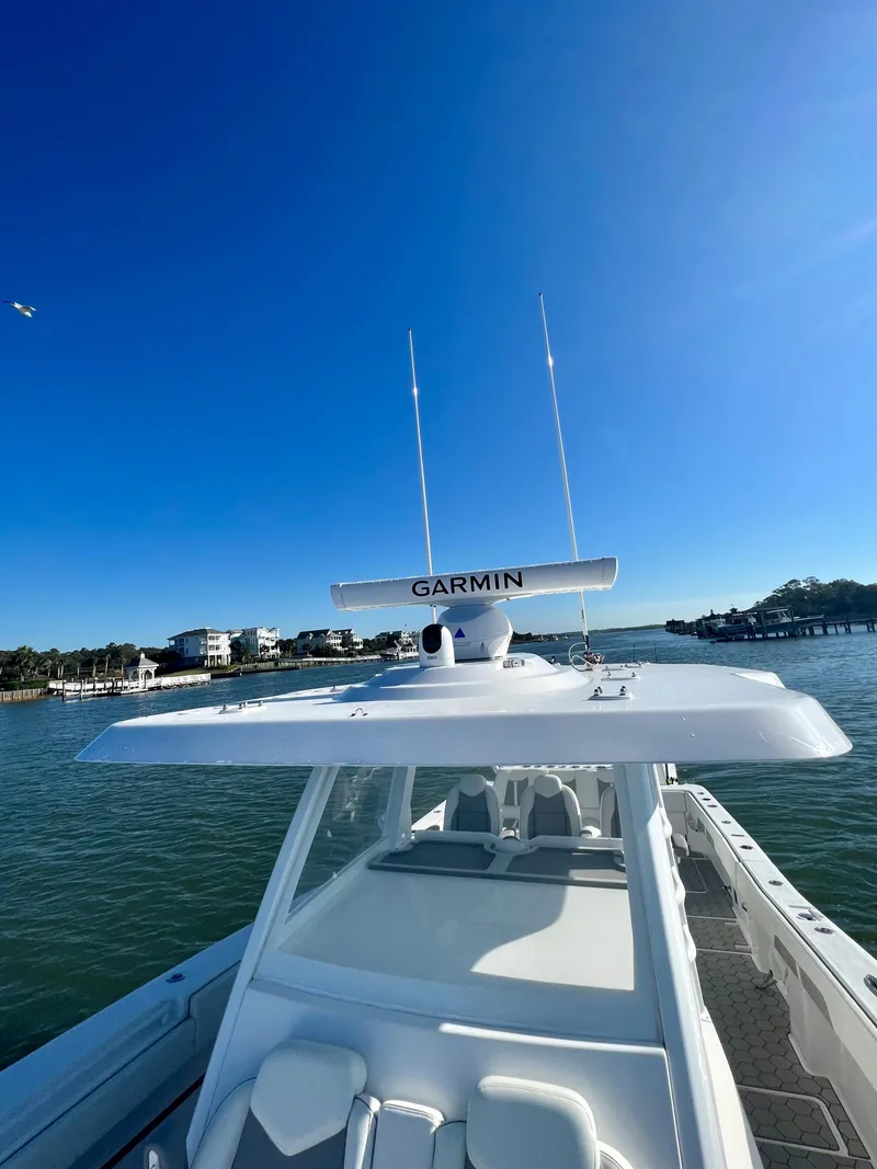 Slide: The Image of 2024 Invincible 43 Open Fisherman boat on water with Garmin radar. - 28