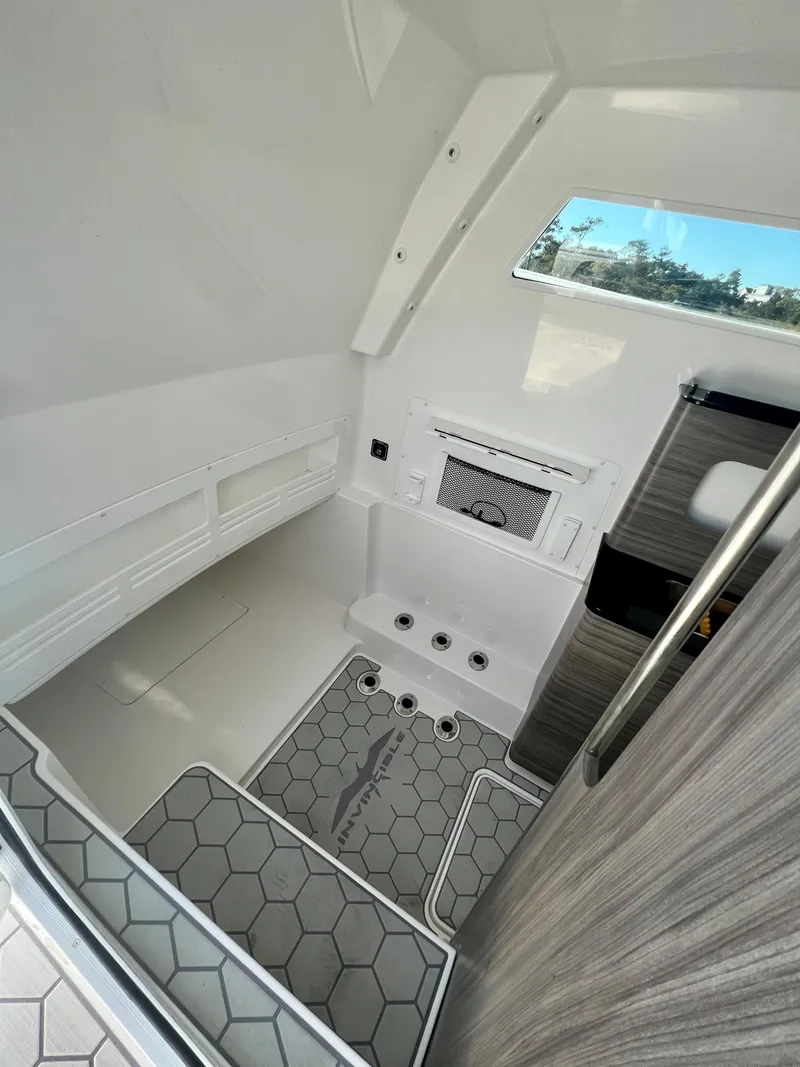 Slide: The Image of 2024 Invincible 43 Open Fisherman cabin interior with modern design and hexagonal flooring. - 20