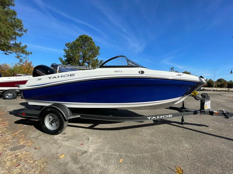 Slide: The Image of 2024 Tahoe 185 S boat on trailer in outdoor setting. - 2