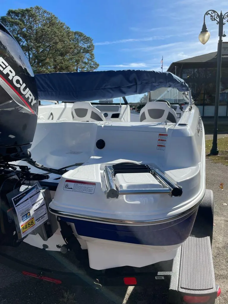 Slide: The Image of 2024 Tahoe 185 S boat with Mercury outboard motor, docked outdoors. - 7