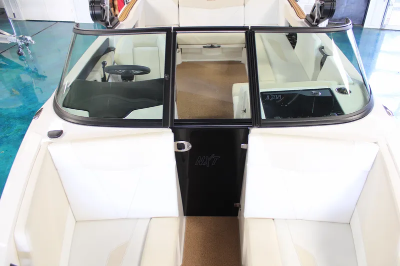 Slide: The Image of 2024 MasterCraft NXT22 boat interior with white seating and black accents. - 10