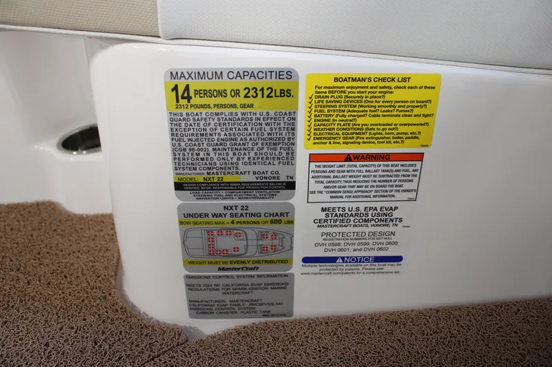 Slide: The Image of 2024 MasterCraft NXT22 capacity and safety labels, 14 persons or 2312 lbs. - 18