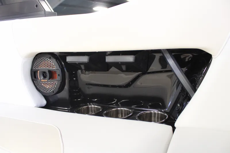 Slide: The Image of 2024 MasterCraft NXT22 boat interior with cup holders and speaker. - 20