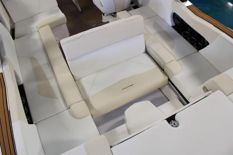 Slide: The Image of 2024 MasterCraft NXT22 boat interior with beige and white seating. - 23