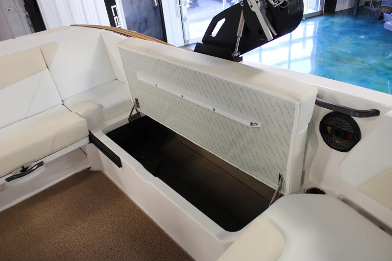 Slide: The Image of 2024 MasterCraft NXT22 boat interior storage compartment with open seat cushion. - 24