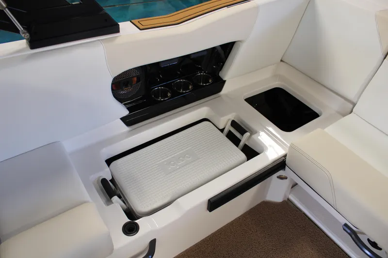 Slide: The Image of 2024 MasterCraft NXT22 boat interior with built-in cooler and storage compartments. - 26