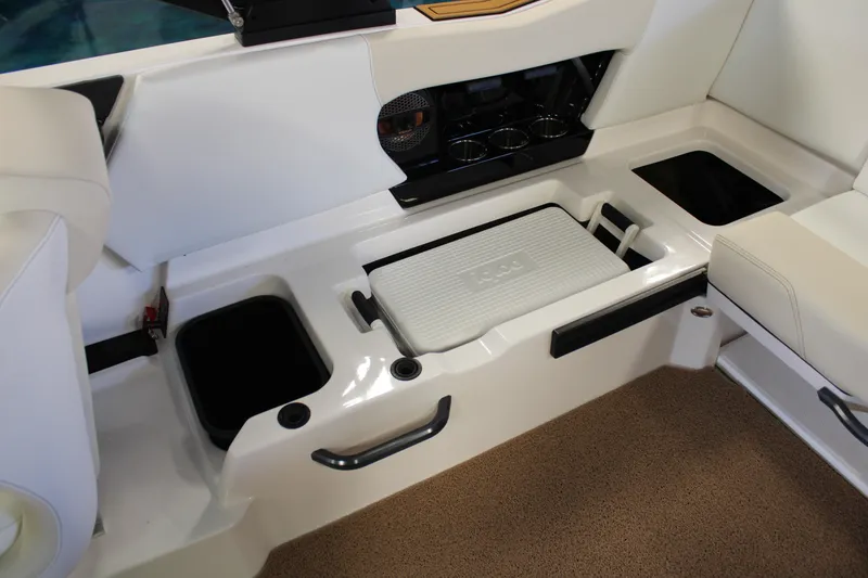 Slide: The Image of 2024 MasterCraft NXT22 boat interior with storage compartments and seating. - 27
