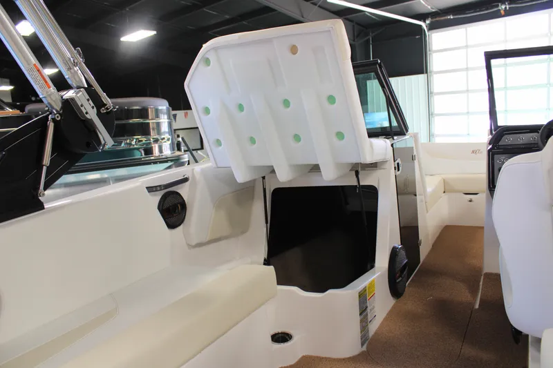 Slide: The Image of 2024 MasterCraft NXT22 boat interior with open storage compartment. - 29
