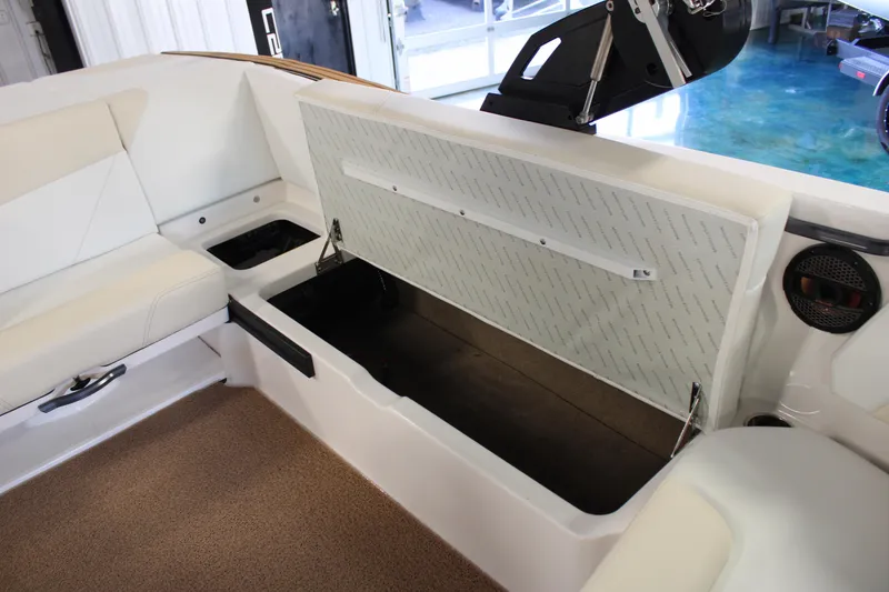 Slide: The Image of 2024 MasterCraft NXT22 boat interior storage compartment with open seat cushion. - 30